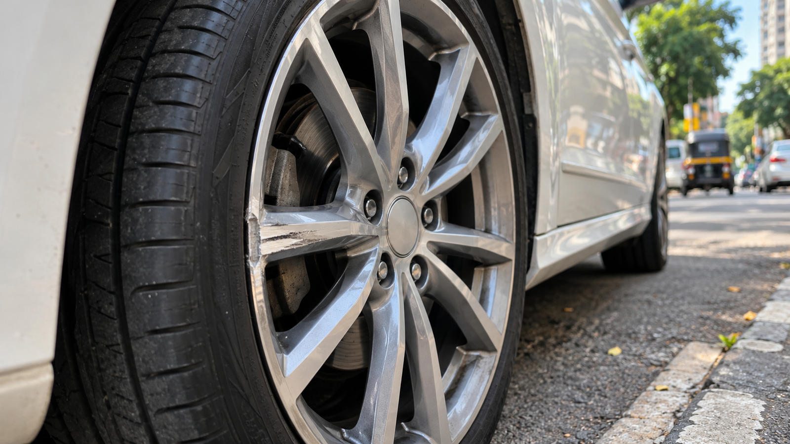 Scratched alloy wheel showing minor curb damage on a car in Mumbai.
